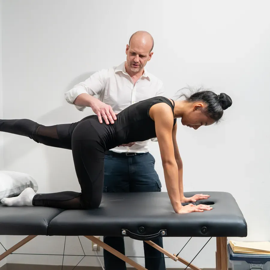 Dr. Edward guiding a patient through a core stability exercise for back pain at Chatsworth Physical Therapy