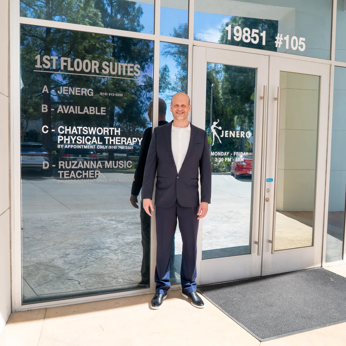 Dr. Edward Shut standing outside Chatsworth Physical Therapy beside the clinic entrance at 19851 Nordhoff Place.